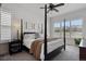 Bright bedroom featuring a four-poster bed, plantation shutters, and neutral decor at 328 Simmental Loop, Castle Rock, CO 80104