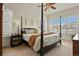 Bedroom with a four-poster bed, plantation shutters, and neutral decor at 328 Simmental Loop, Castle Rock, CO 80104