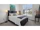 Comfortable bedroom showcasing a large window, neutral tones, and stylish decor at 328 Simmental Loop, Castle Rock, CO 80104