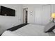 Simple bedroom with a mounted TV, sliding closet doors, and a cozy, inviting atmosphere at 328 Simmental Loop, Castle Rock, CO 80104