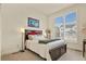 Bedroom with large window, carpet, decorative lighting, and black headboard on bed with neutral bedding at 328 Simmental Loop, Castle Rock, CO 80104