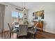 Bright dining room featuring a wooden table with seating for four and stylish pendant lighting at 328 Simmental Loop, Castle Rock, CO 80104