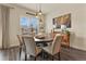 Inviting dining area with a round table, modern lighting, and a scenic window view at 328 Simmental Loop, Castle Rock, CO 80104