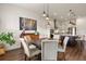 Dining area with wood table and chairs, pendant lighting, and an adjacent modern kitchen at 328 Simmental Loop, Castle Rock, CO 80104