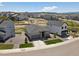 An aerial view of the house, with green front lawn and new neighborhood and playground at 328 Simmental Loop, Castle Rock, CO 80104