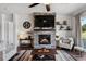 Inviting living area featuring a stone fireplace with a mounted TV and comfortable seating at 328 Simmental Loop, Castle Rock, CO 80104