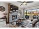 Living area features a cozy stone fireplace and sliding door access to a patio at 328 Simmental Loop, Castle Rock, CO 80104