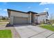 Charming single-story home featuring a well-maintained lawn, brick accents, and an attached two-car garage at 328 Simmental Loop, Castle Rock, CO 80104