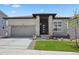 Charming single-story home featuring a well-maintained lawn, brick accents, and an attached two-car garage at 328 Simmental Loop, Castle Rock, CO 80104