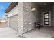 Cozy front porch with stylish seating and stacked stone accents, creating inviting curb appeal at 328 Simmental Loop, Castle Rock, CO 80104