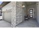 Close up of the front porch showing the grey stonework and a table for two at 328 Simmental Loop, Castle Rock, CO 80104