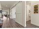 Bright hallway showcasing modern sliding doors and hardwood flooring throughout at 328 Simmental Loop, Castle Rock, CO 80104