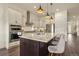 Gourmet kitchen featuring white cabinetry, stainless steel appliances, and a spacious island at 328 Simmental Loop, Castle Rock, CO 80104