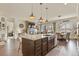 Kitchen island with sink overlooks the fireplace, living area, and dining area at 328 Simmental Loop, Castle Rock, CO 80104