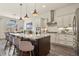 Open kitchen featuring a large island, stainless steel appliances, and pendant lighting at 328 Simmental Loop, Castle Rock, CO 80104