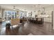 Spacious living room with hardwood floors, seamlessly connected to the modern kitchen and dining area, perfect for entertaining at 328 Simmental Loop, Castle Rock, CO 80104