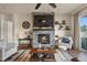 Inviting living room with stone fireplace, stylish decor, and backyard views at 328 Simmental Loop, Castle Rock, CO 80104
