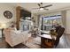 Cozy living room with a stone fireplace, comfortable seating, and lots of natural light at 328 Simmental Loop, Castle Rock, CO 80104