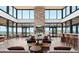 Spacious lobby features a fireplace, modern lighting, and walls of windows at 328 Simmental Loop, Castle Rock, CO 80104