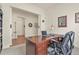 Well-lit office with a wooden desk, comfortable chair, and neutral decor at 328 Simmental Loop, Castle Rock, CO 80104
