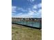 Outdoor tennis courts with blue and green surface and black fence, set against a backdrop of homes and a clear sky at 328 Simmental Loop, Castle Rock, CO 80104