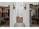 Dual walk-in closets leading to bathroom with hardwood floors and bright lighting at 328 Simmental Loop, Castle Rock, CO 80104