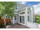 Back exterior view, complete with a wooden deck, sliding glass doors, and well-manicured trees at 5190 Buckingham Rd, Boulder, CO 80301