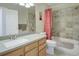 The bright bathroom features a vanity with drawers, a shower with tile surround, and a large mirror at 5190 Buckingham Rd, Boulder, CO 80301