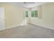 Inviting bedroom with cozy carpeting, a ceiling fan, and bright natural light streaming through the windows at 5190 Buckingham Rd, Boulder, CO 80301