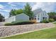 Two story exterior elevation with well-kept landscaping, and detached garage/storage units with extra parking at 5190 Buckingham Rd, Boulder, CO 80301