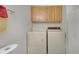 Functional laundry room with cabinets above the standard side-by-side washer and dryer at 5190 Buckingham Rd, Boulder, CO 80301