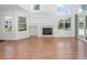 Bright living room with hardwood floors, fireplace, large windows, and natural light throughout at 5190 Buckingham Rd, Boulder, CO 80301