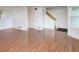 Spacious living room featuring glossy hardwood floors, stairs, and neutral paint throughout at 5190 Buckingham Rd, Boulder, CO 80301