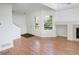 Bright living room featuring hardwood floors, a fireplace, and a large window at 5190 Buckingham Rd, Boulder, CO 80301