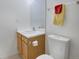 Cozy powder room featuring a single sink vanity, mirror, and nearby toilet for convenience at 5190 Buckingham Rd, Boulder, CO 80301