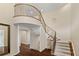 Elegant curved staircase with wrought iron railings at 6623 Esmeralda Dr, Castle Rock, CO 80108