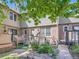Charming backyard with a wooden deck, brick walkways, and beautiful garden beds at 3540 E 5Th Ave, Denver, CO 80206