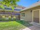Backyard with green lawn and a privacy fence lined with tall ornamental grasses at 3540 E 5Th Ave, Denver, CO 80206