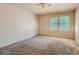 Spacious carpeted bedroom with window and ceiling fan at 3540 E 5Th Ave, Denver, CO 80206