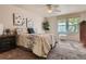 Bedroom features a ceiling fan, large window, and neutral toned decor at 3540 E 5Th Ave, Denver, CO 80206