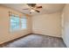 Neutral bedroom with a ceiling fan, carpeted floor, and a bright window at 3540 E 5Th Ave, Denver, CO 80206