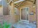 Welcoming brick-covered entryway leading to a front door with a side window and modern design at 3540 E 5Th Ave, Denver, CO 80206