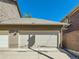 Two car garage with white door and neutral siding at 3540 E 5Th Ave, Denver, CO 80206
