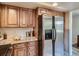 Kitchen featuring granite countertops, stainless steel refrigerator, and wooden cabinetry at 3540 E 5Th Ave, Denver, CO 80206