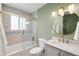 Updated bathroom features a shower with glass enclosure, stylish vanity, and modern finishes at 2213 E Panama Dr, Centennial, CO 80121