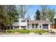 Charming two-story home with manicured front lawn, a cute fence, and beautiful trees at 2213 E Panama Dr, Centennial, CO 80121
