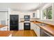 White kitchen cabinets, updated appliances, butcher block countertop and hardwood floors at 2213 E Panama Dr, Centennial, CO 80121