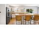 Bright kitchen with white cabinets, a butcher block island, and modern black appliances at 2213 E Panama Dr, Centennial, CO 80121