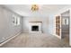 Inviting living room with a brick fireplace, neutral tones, and natural light from a window at 2213 E Panama Dr, Centennial, CO 80121