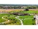 Aerial view showcasing park with walking trails, lush greenery, bridge and nearby buildings at 129 Mesa Way, Superior, CO 80027